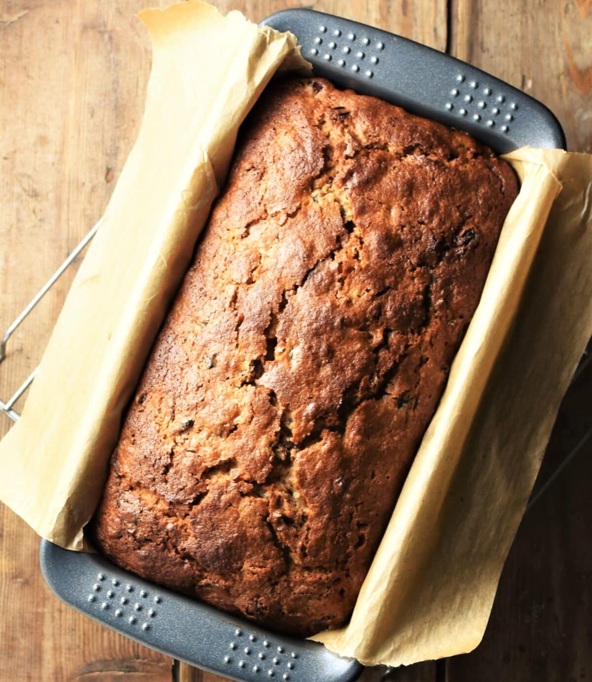 Top down view of tea cake in loaf pan lined with parchment.