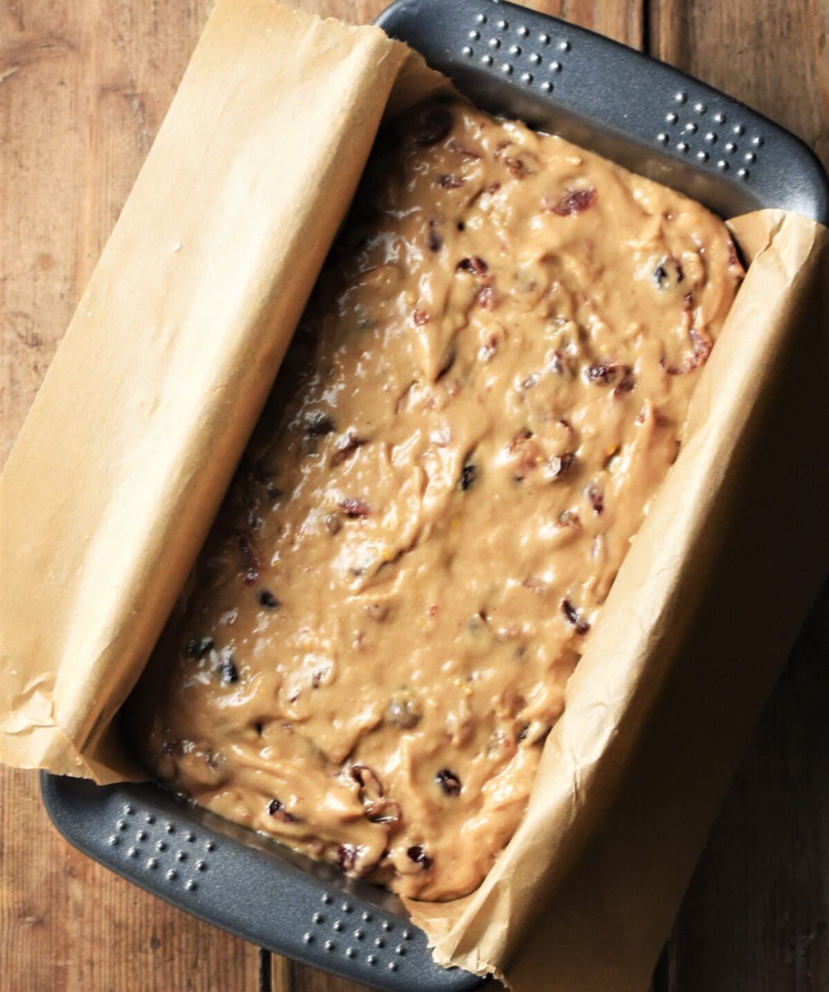 Rooibos tea cake batter in loaf pan lined with parchment.
