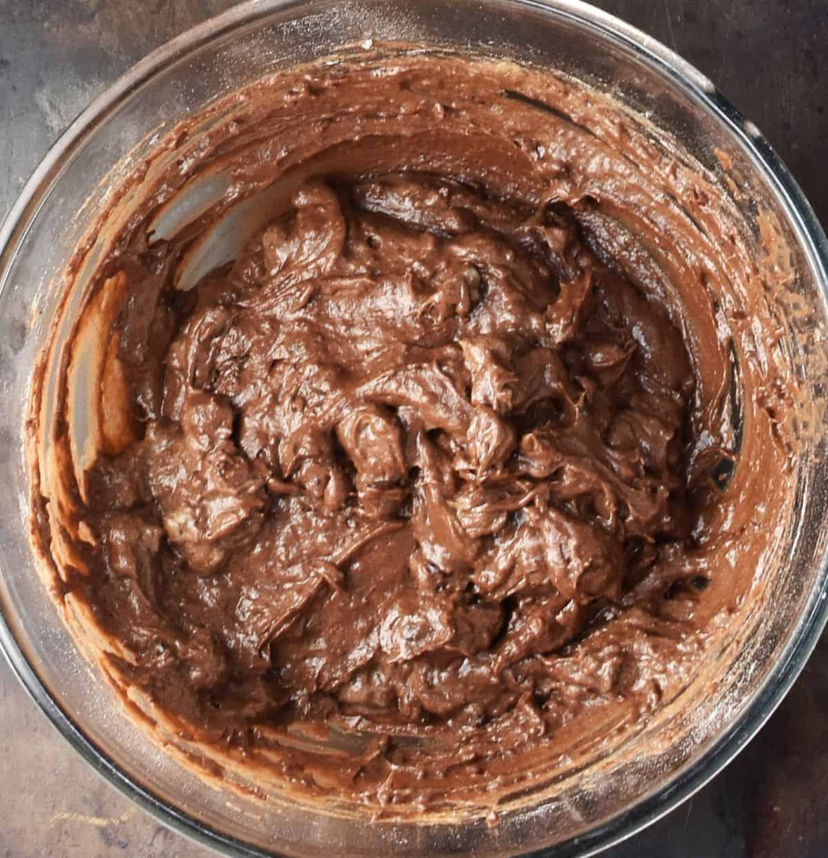 Avocado chocolate muffin batter in glass bowl.
