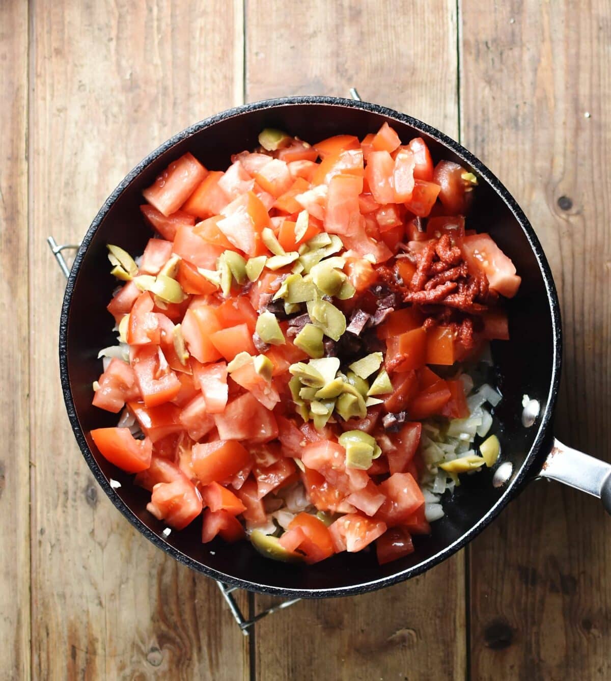 Chopped tomatoes inside shallow pan.