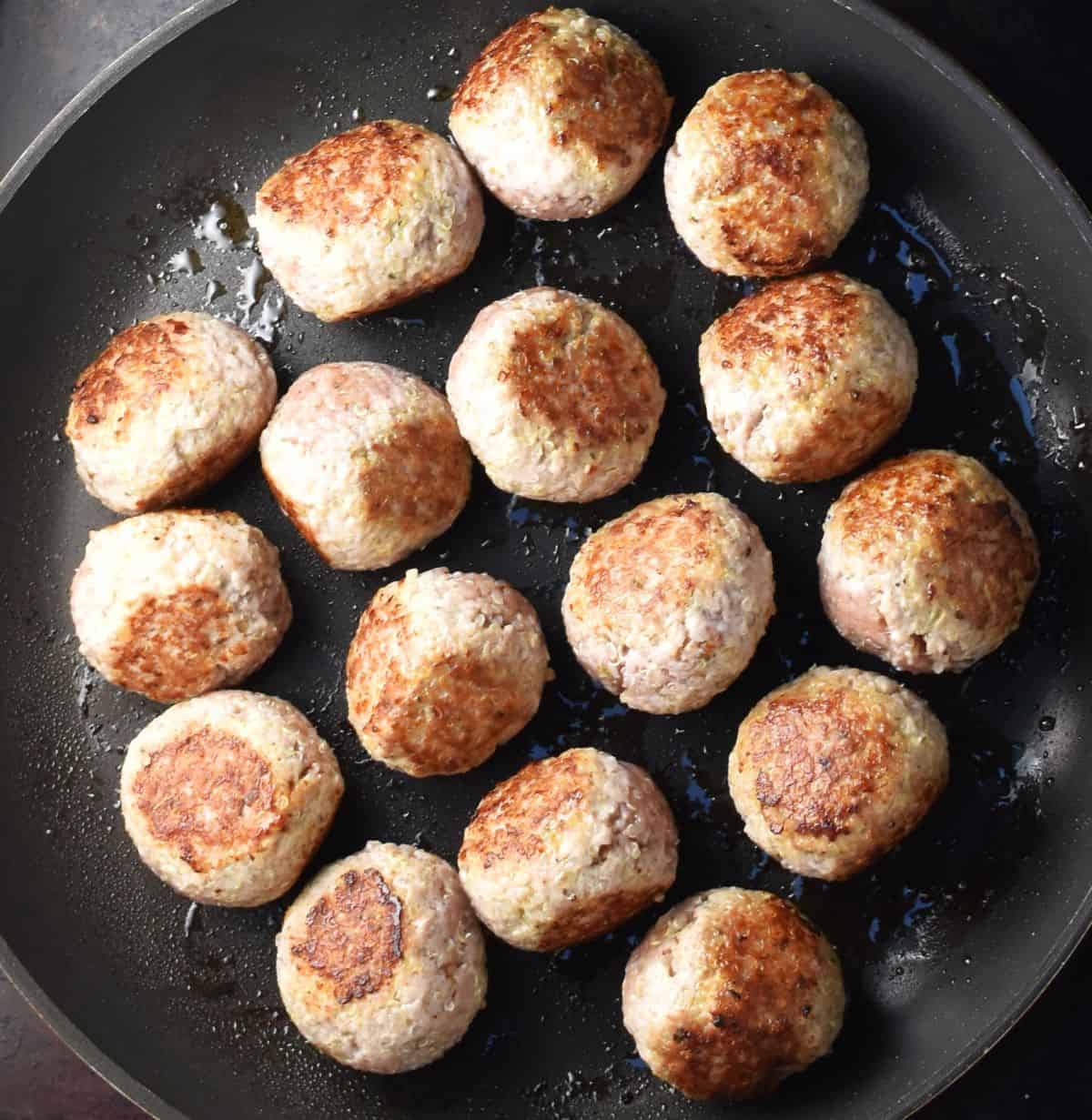 Browned meatballs with quinoa and turkey in large pan.