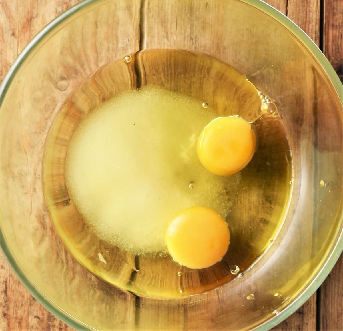 2 eggs, sugar and oil in mixing bowl.
