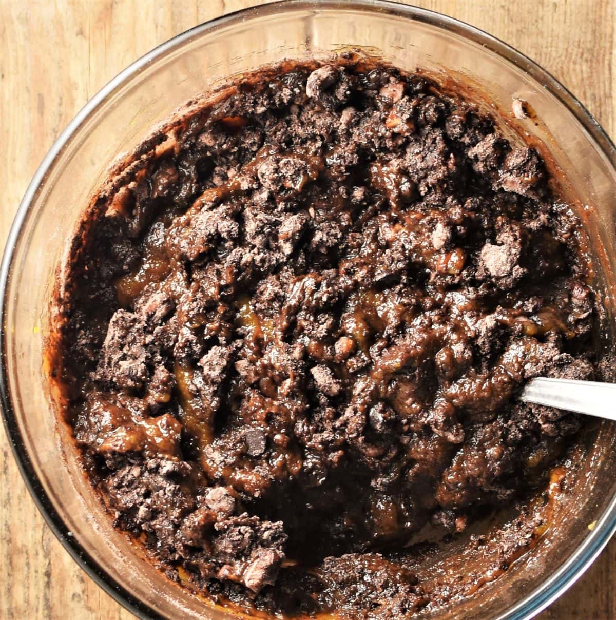Pumpkin brownies batter in mixing bowl with spoon.