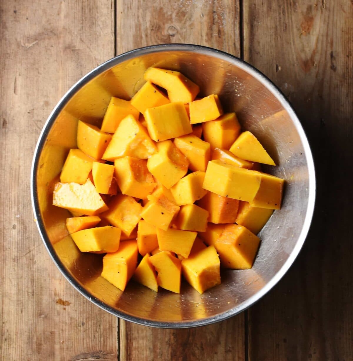 Pumpkin cubes in large metal bowl.