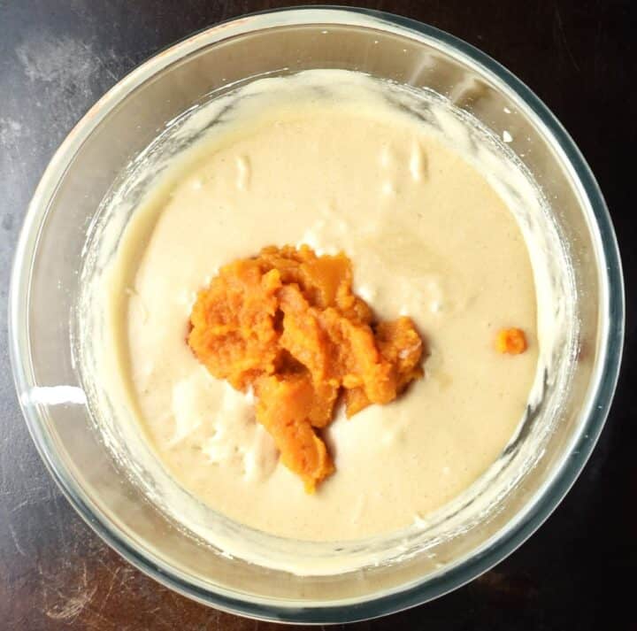 Wet mixture with pumpkin puree in mixing bowl.