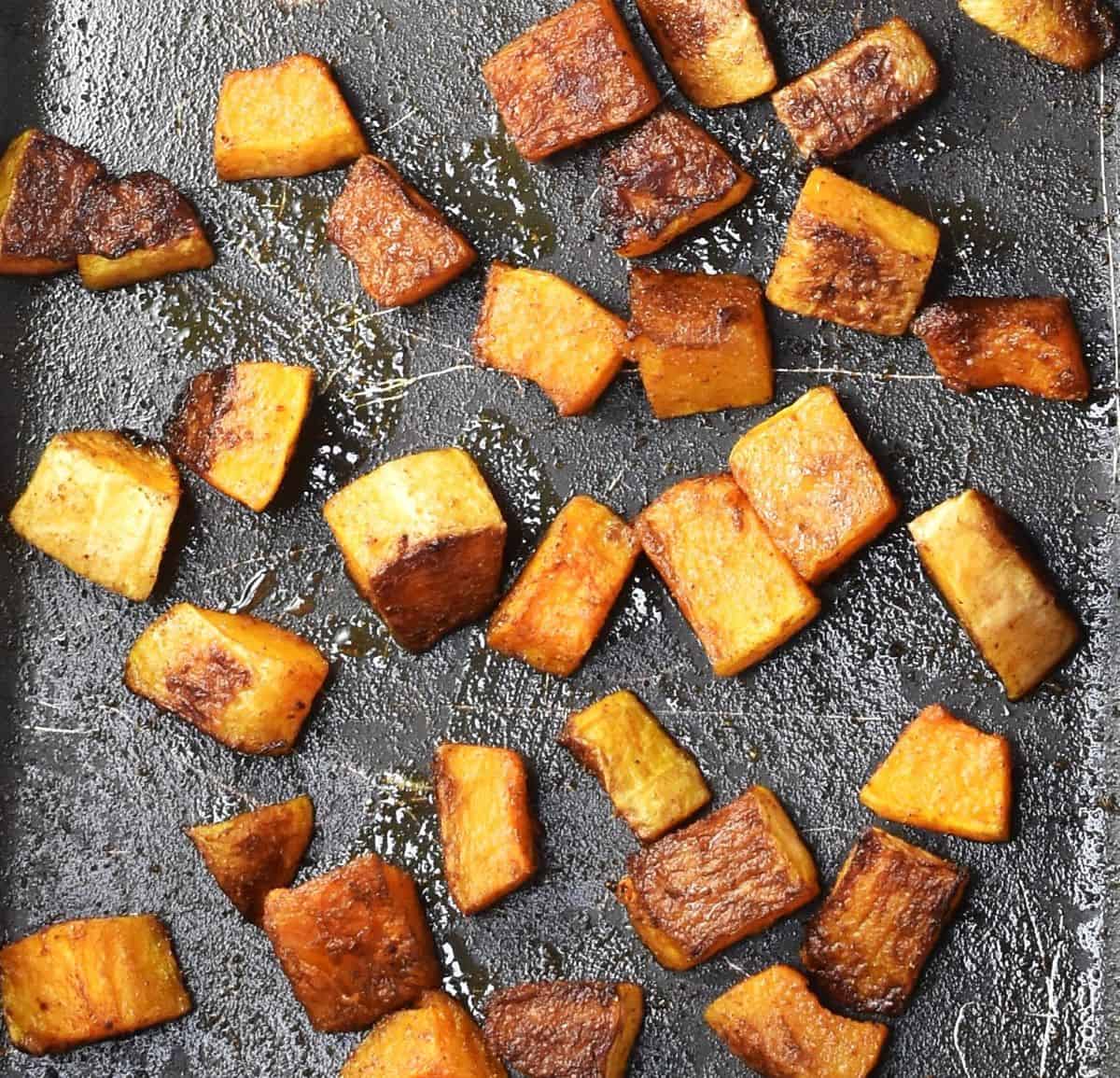 Cubed roasted butternut squash in pan.