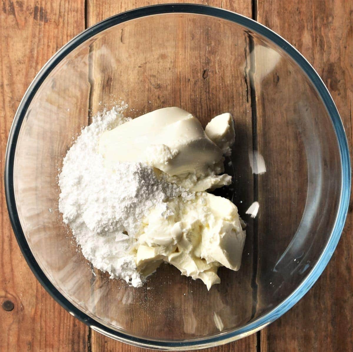 Cream cheese and powdered sugar in mixing bowl.