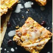Top down view of square fruit cake slices on top of grey surface.