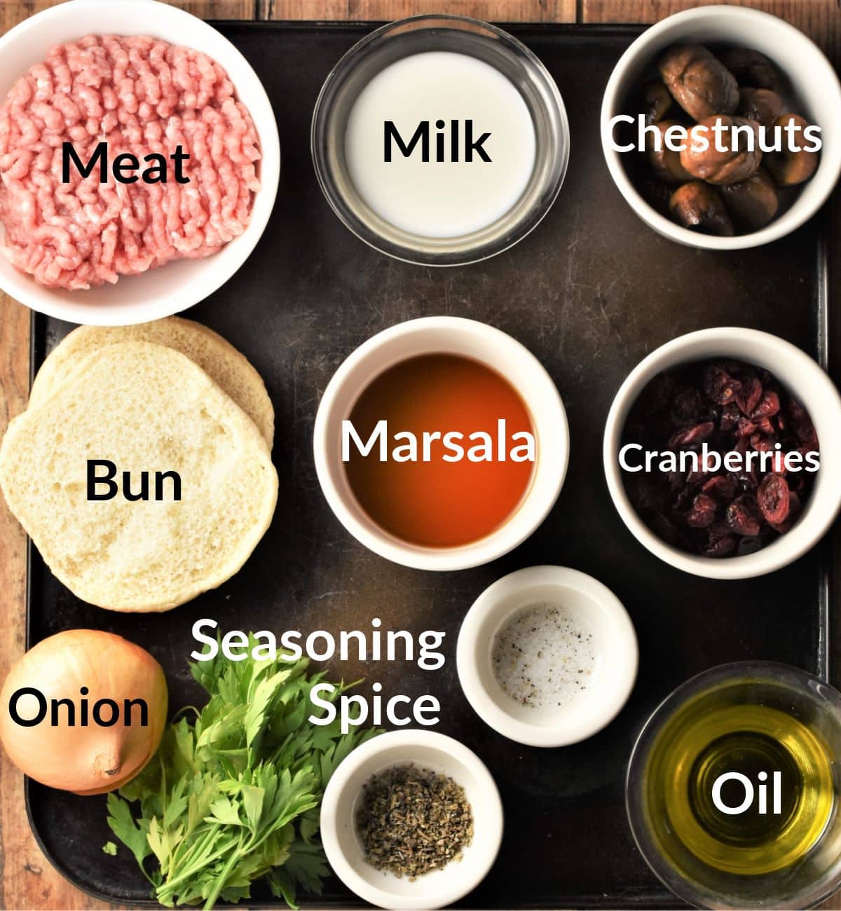 Stuffing meatballs ingredients in individual dishes.