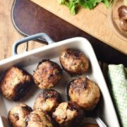 Stuffing meatballs in rectangular dish.