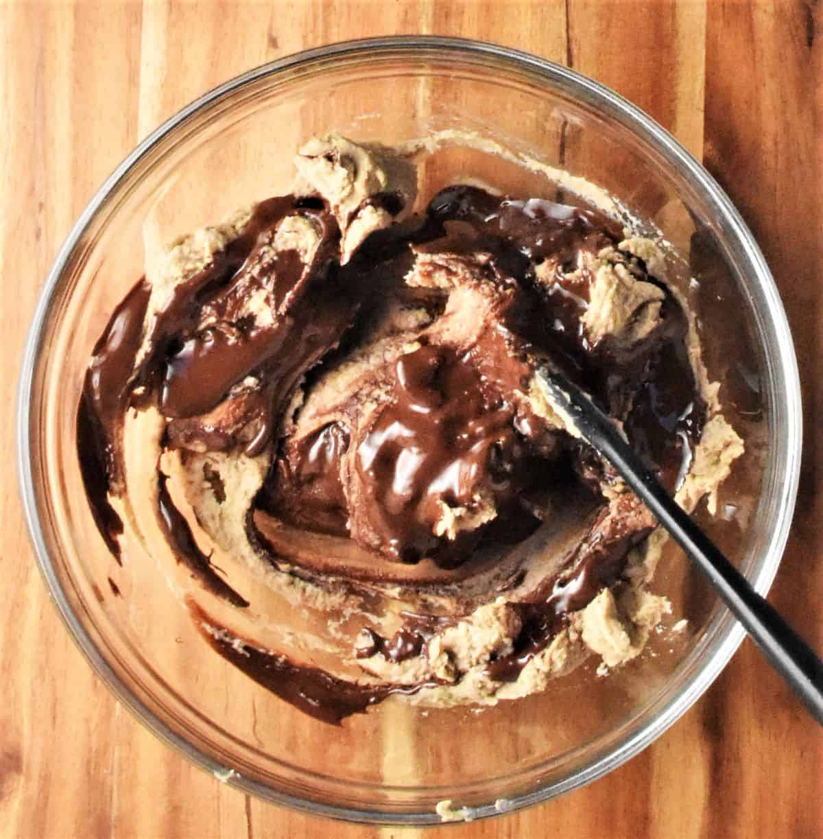 Combining chocolate with chestnut mixture for truffles in bowl.