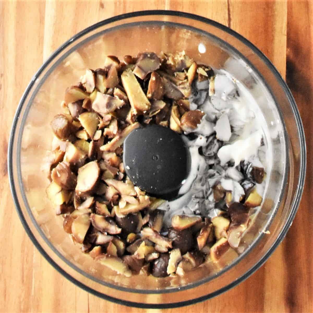 Chopped chestnuts and cream in food processor.