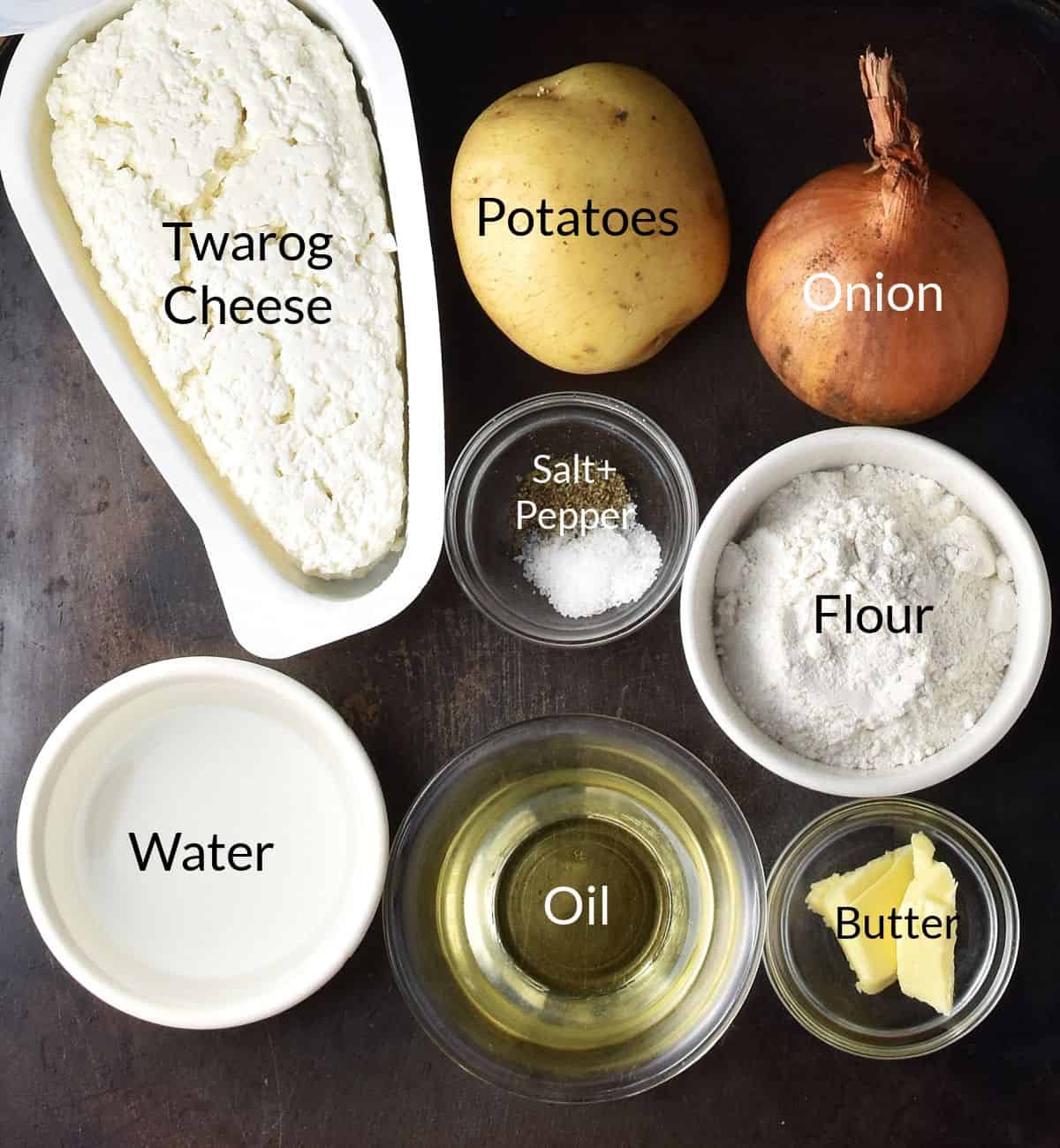 Top down view of ingredients for Polish potato and cheese pierogi in individual dishes.
