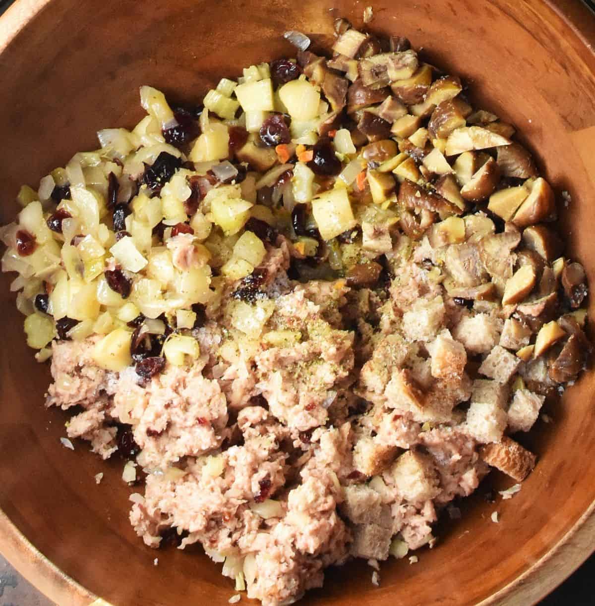 Fruit and vegetable mixture and smashed vegan sausages in wooden bowl.