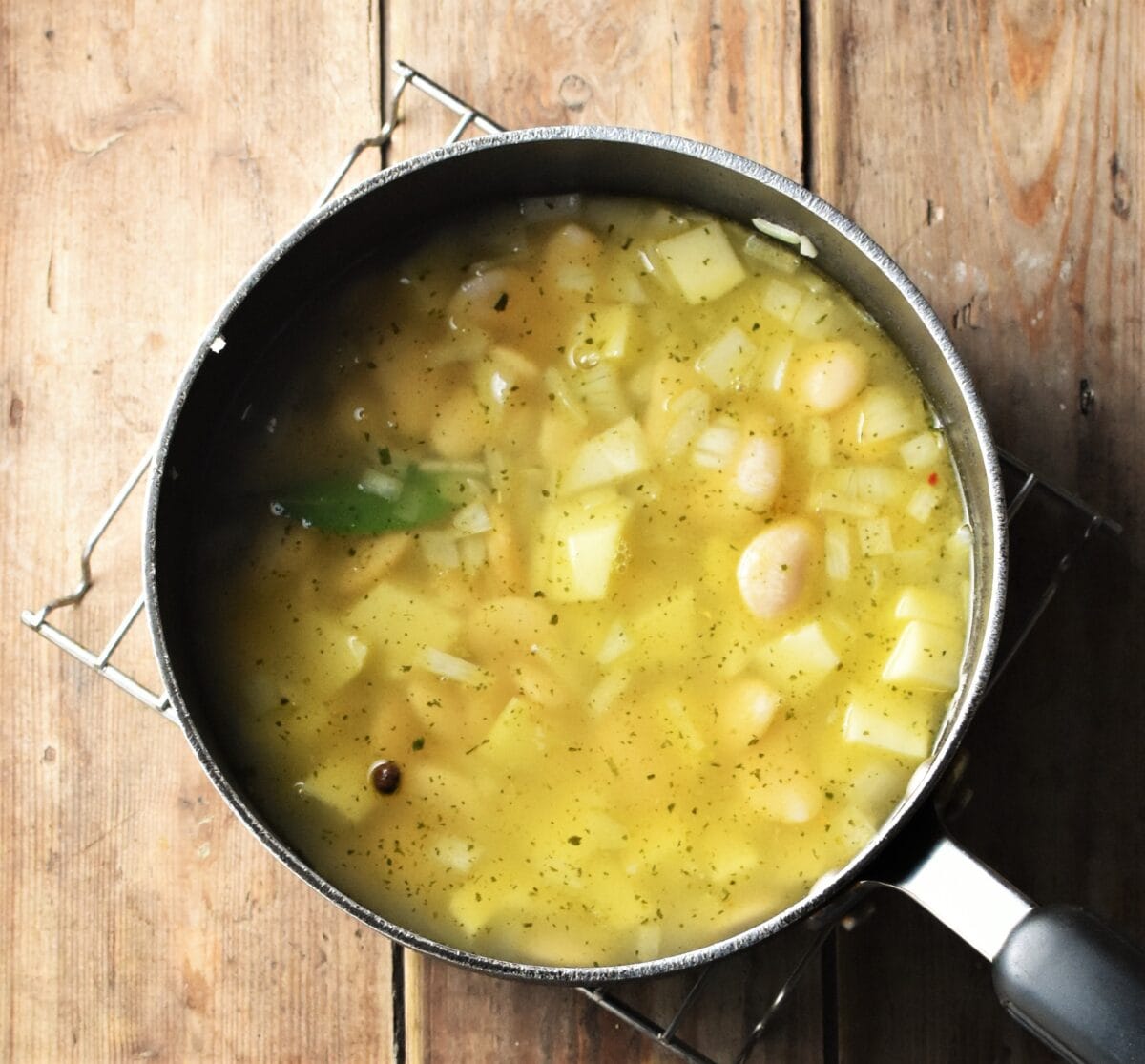 Butter beans and cubed potatoes with stock in large pot.