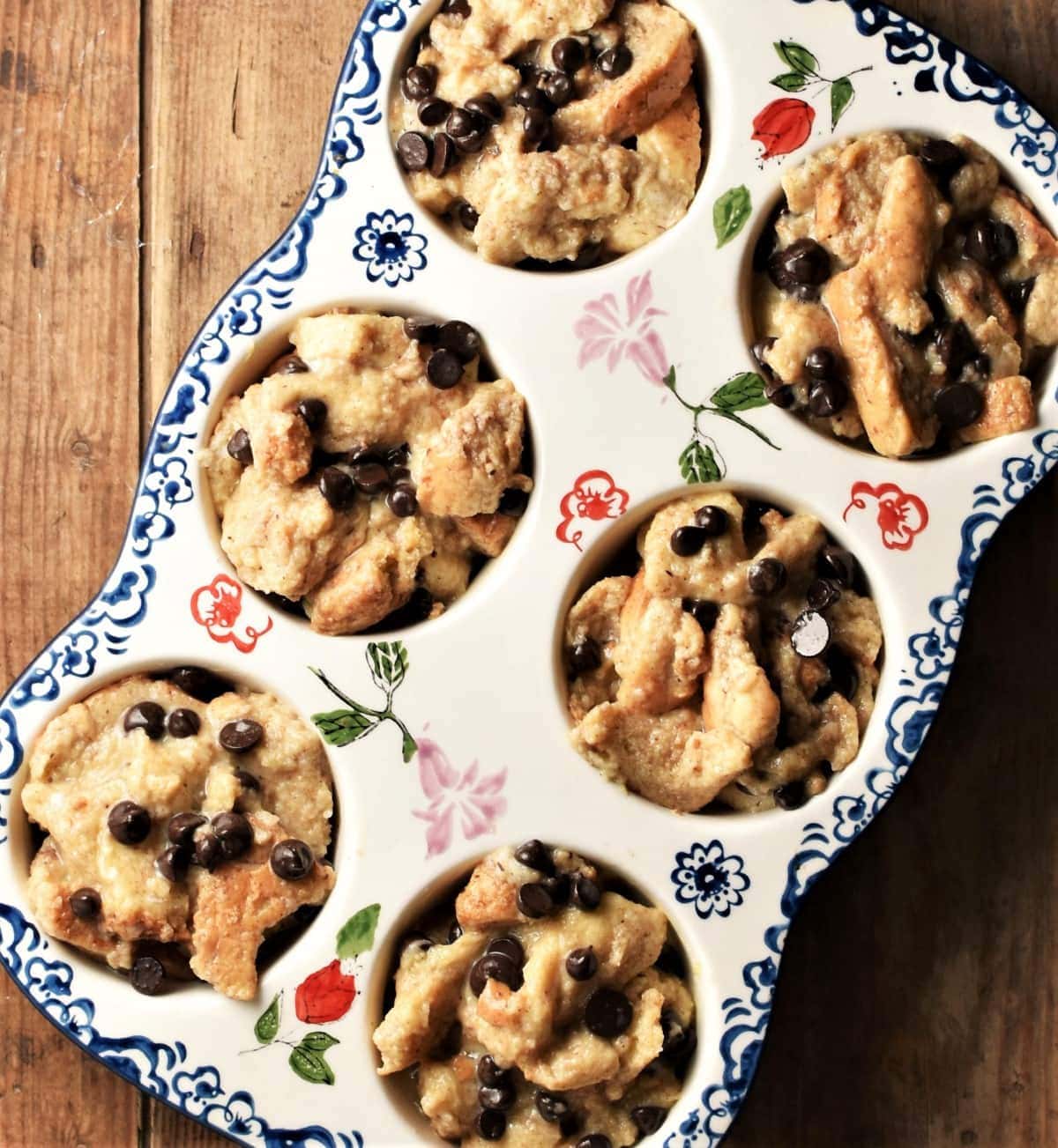 Top down view of french toast muffin mixture in 6-hole ceramic pan.