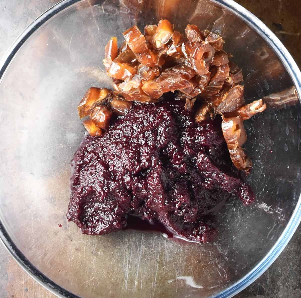 Pureed beets and chopped dates in glass bowl.