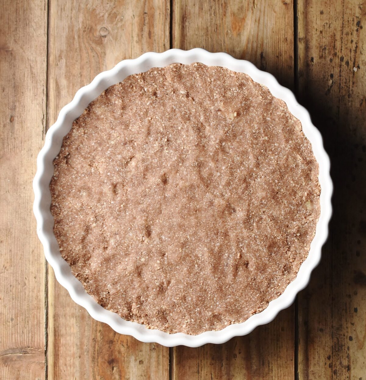 Pie base in white dish.