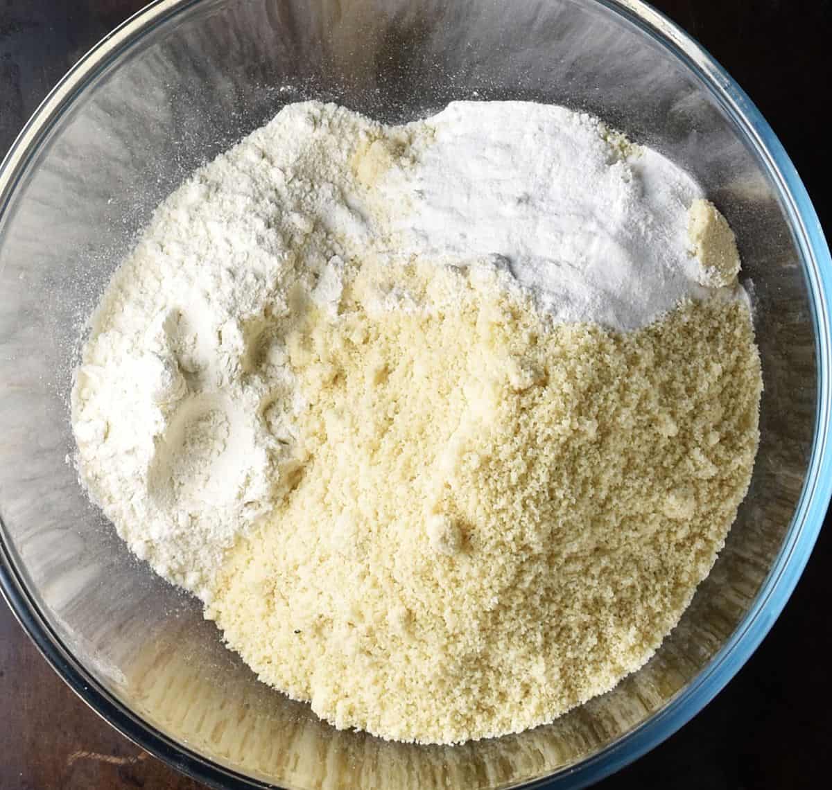 Almond flour and flour in glass bowl.