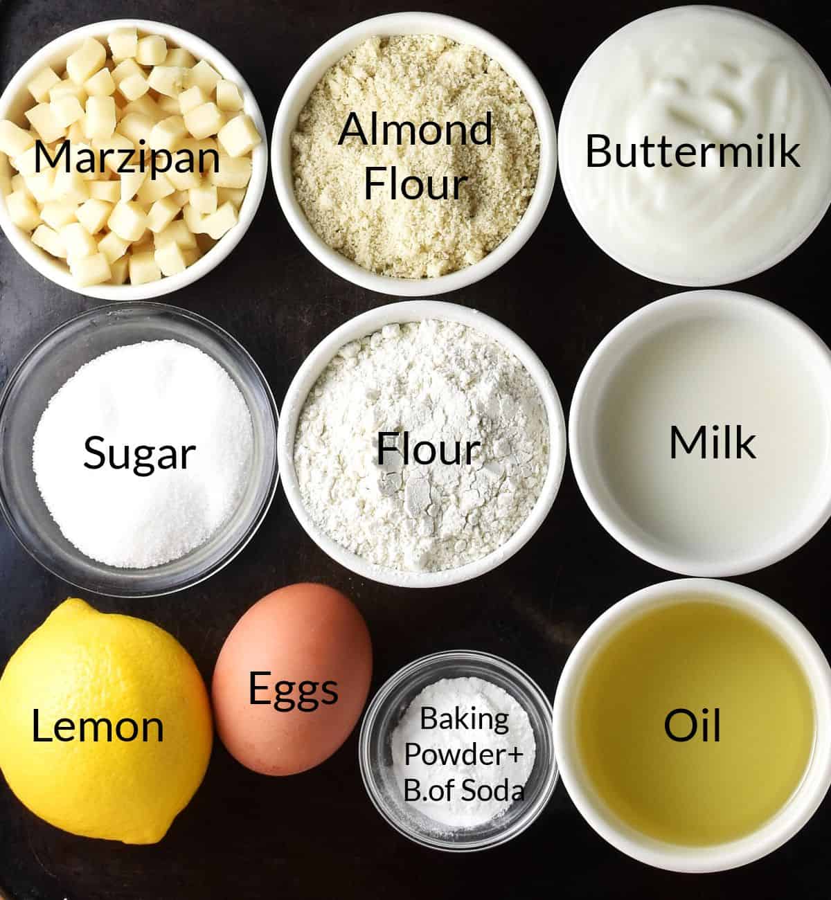 Top down view of ingredients for marzipan muffins in individual dishes.