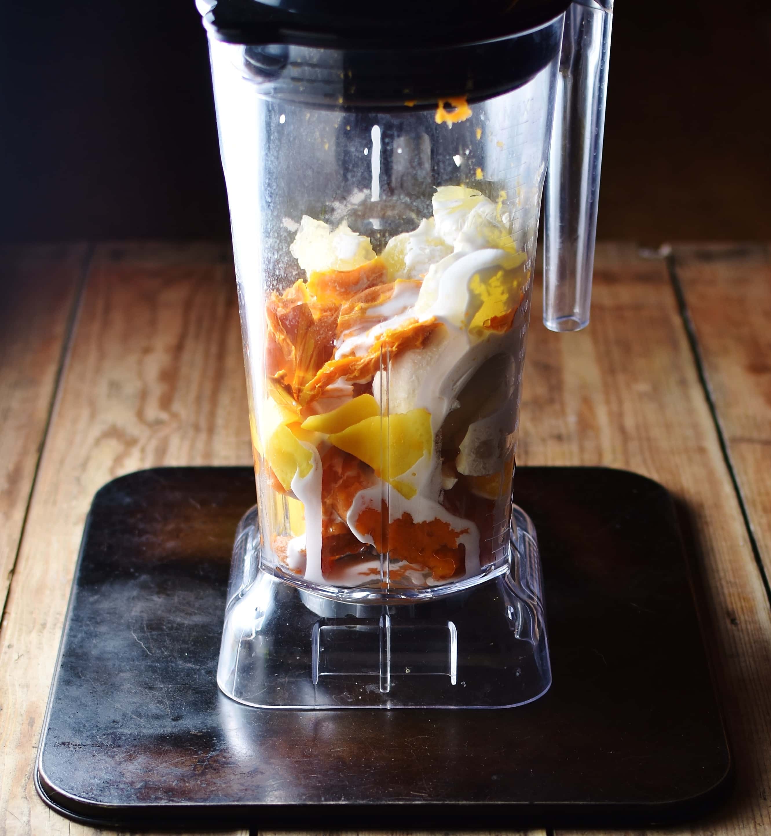 Sweet potato, dried mango and cream inside blender.