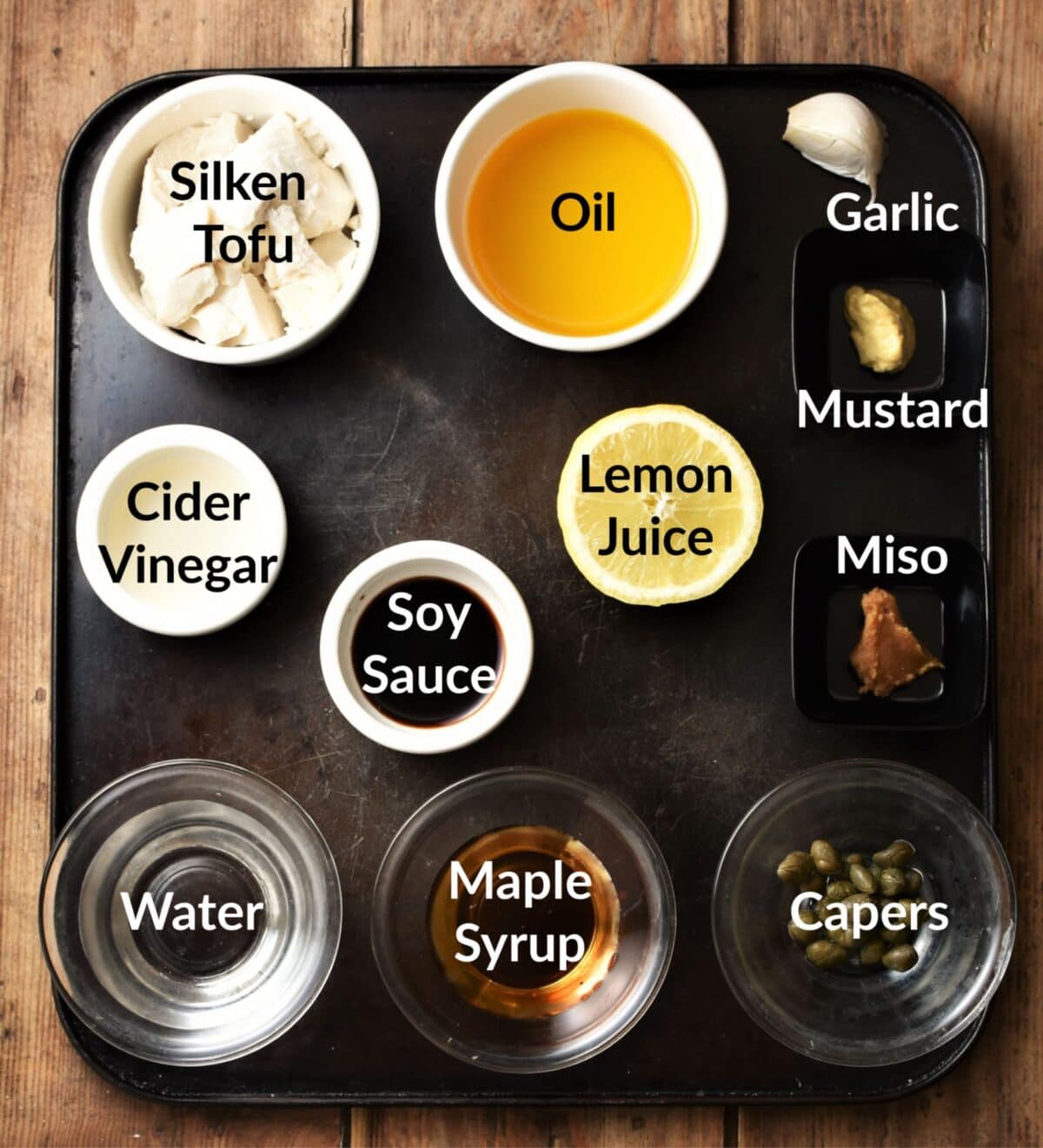 Vegan caesar salad dressing ingredients in individual dishes.