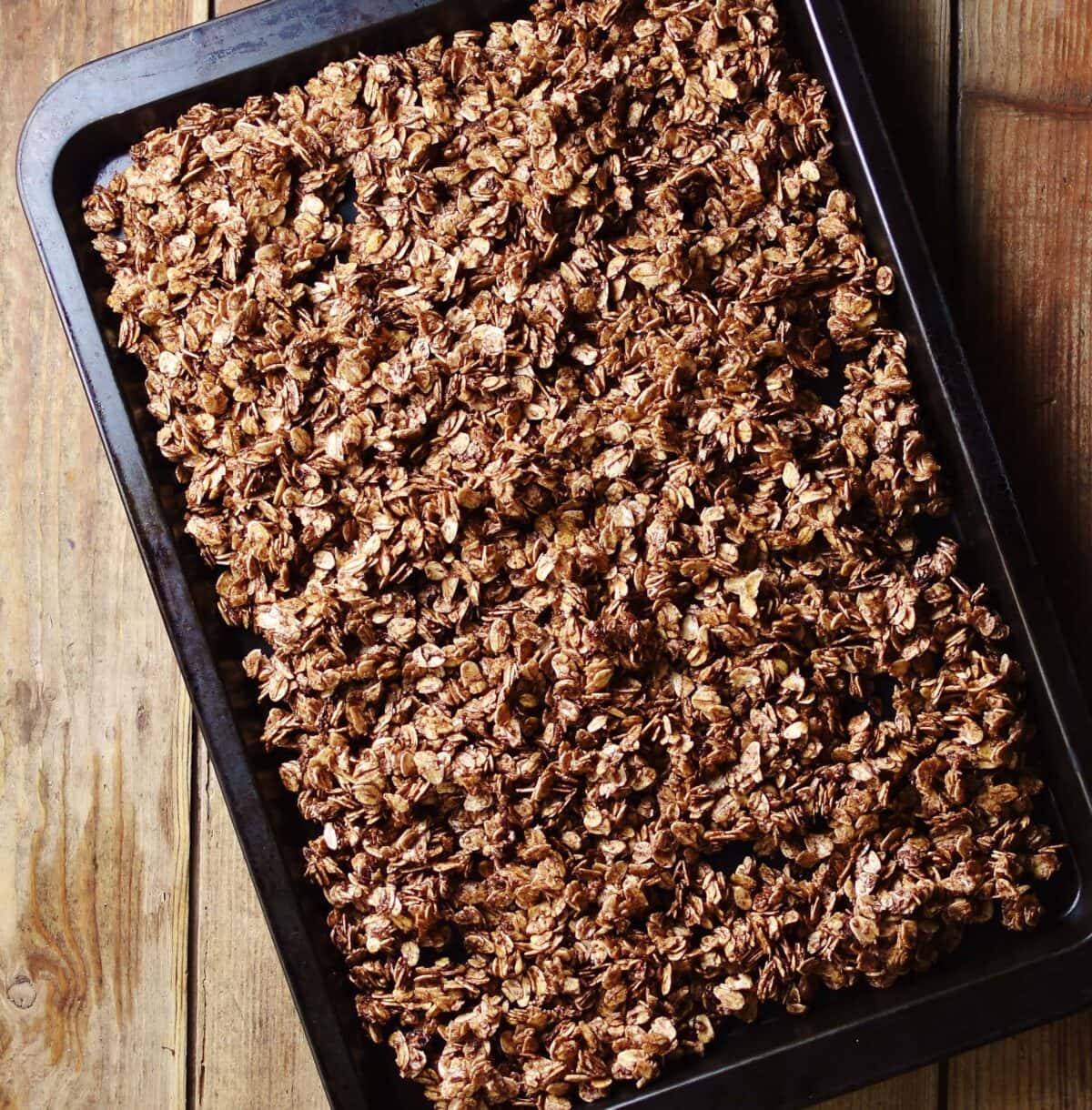 Chocolate granola inside oven tray.