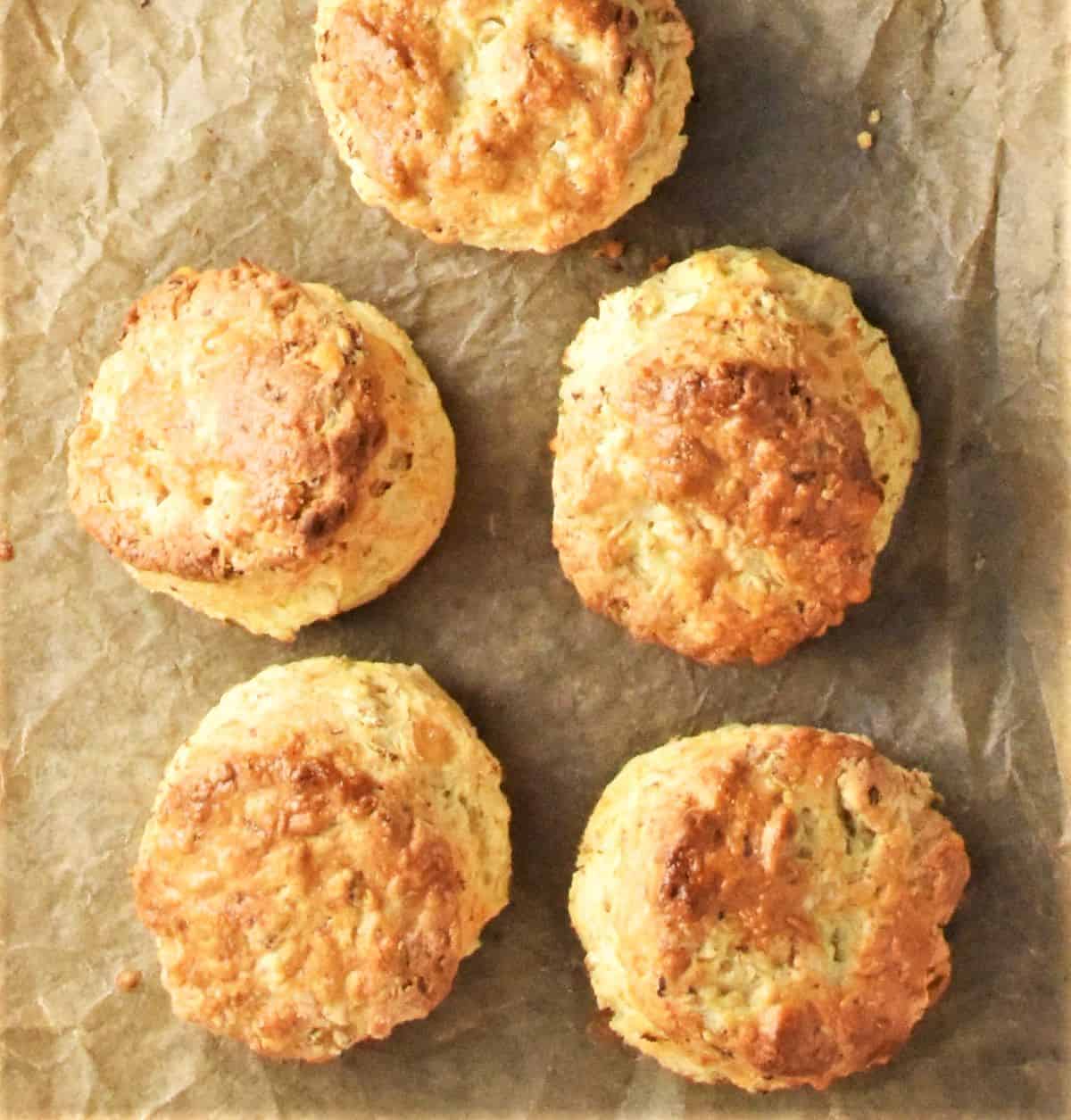 5 scones with nicely browned tops on parchment.