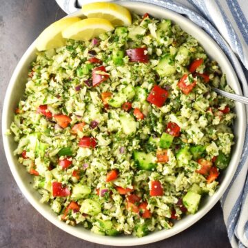 Top down view of cauliflower tabbouleh salad in large bowl.