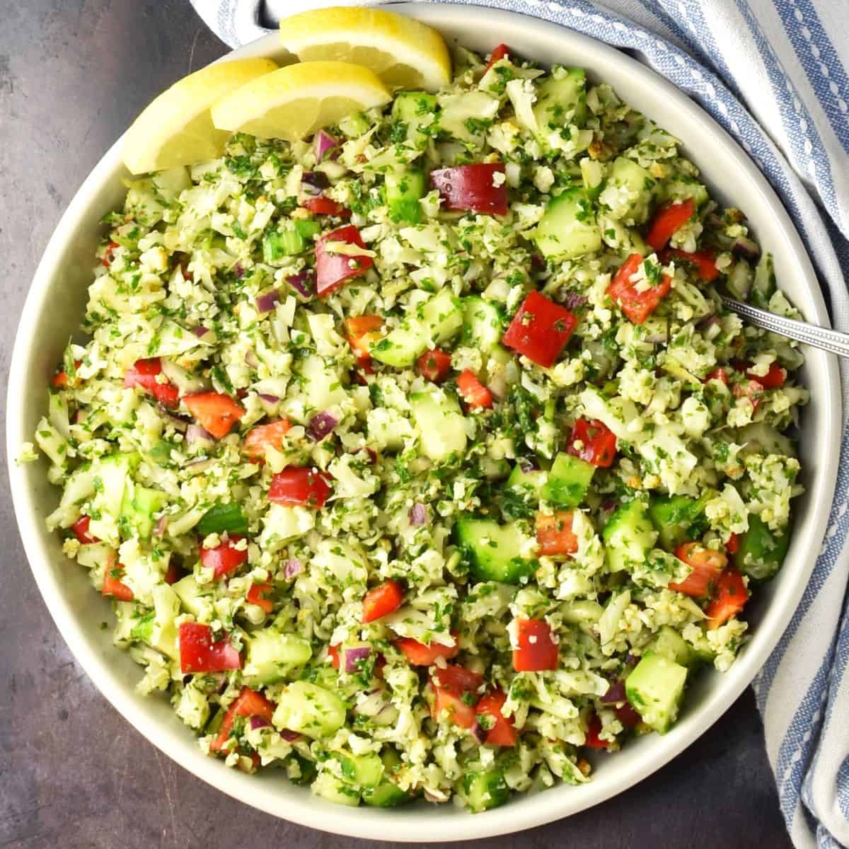 Top down view of cauliflower tabbouleh salad in large bowl.
