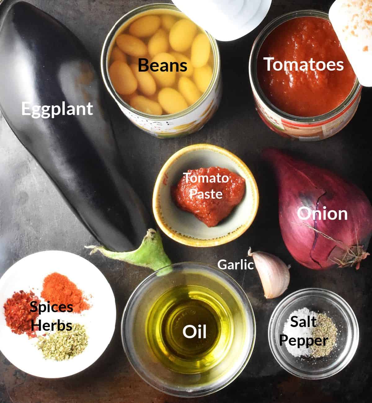 Top down view of eggplant casserole ingredients in individual dishes.