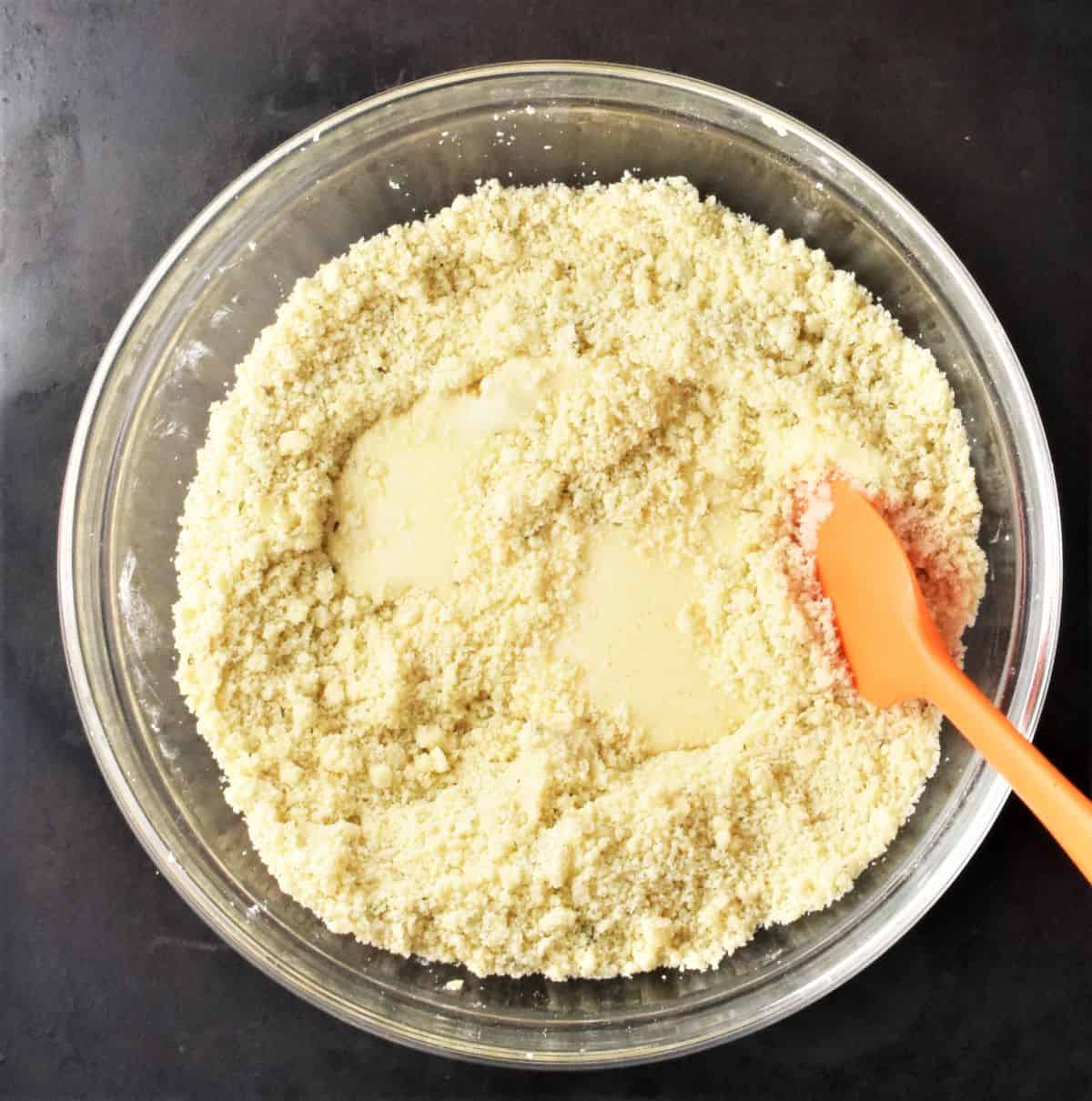 Combining dry scones ingredients with buttermilk in bowl.