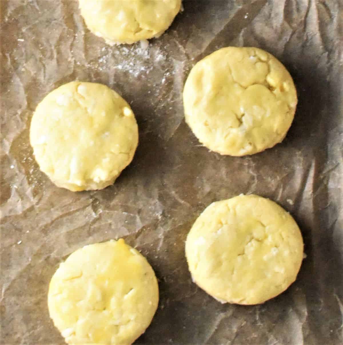 5 scones before baking on top of parchment.