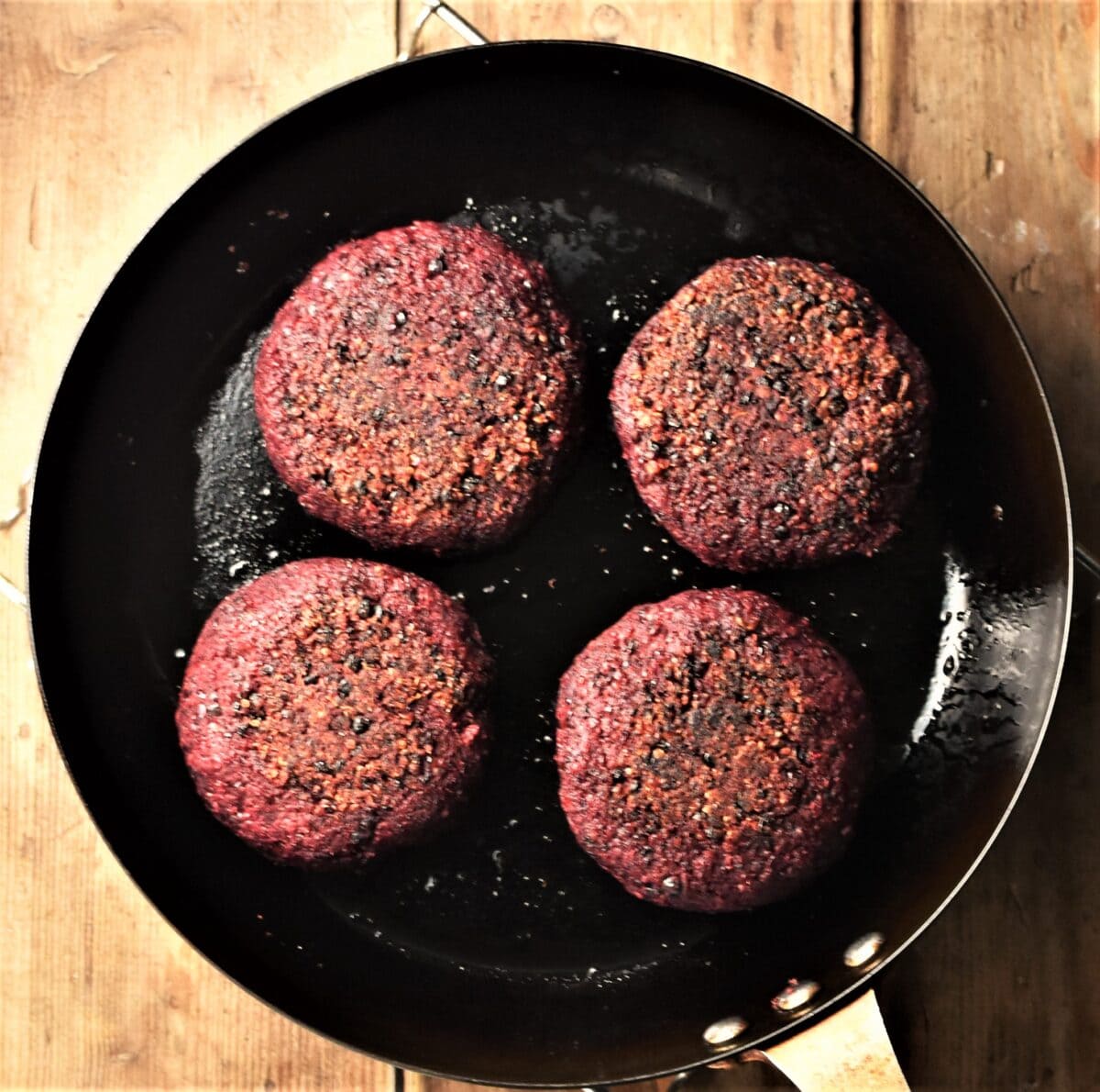 4 beet burgers in skillet.