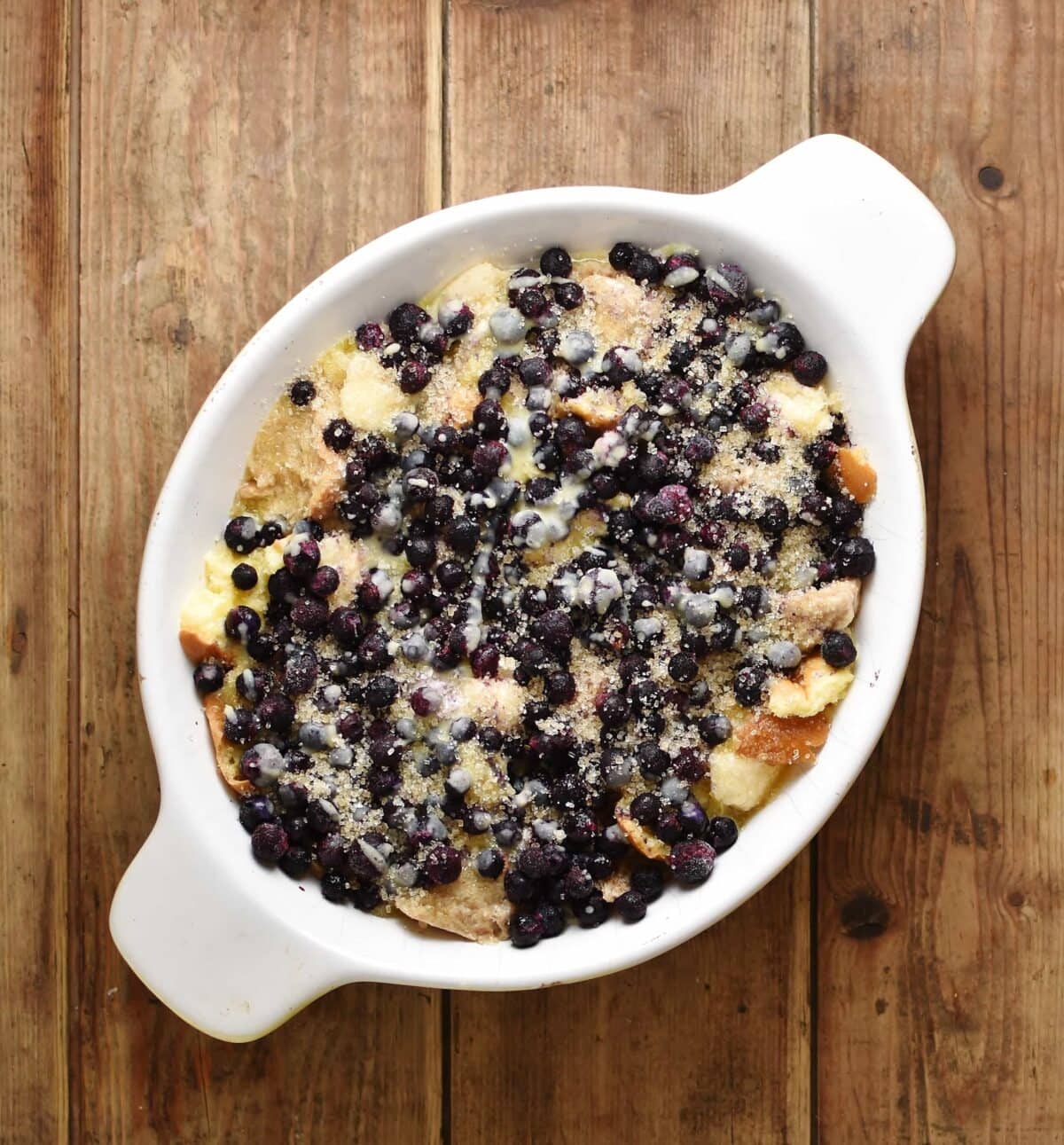 Blueberry french toast casserole in white oval dish.