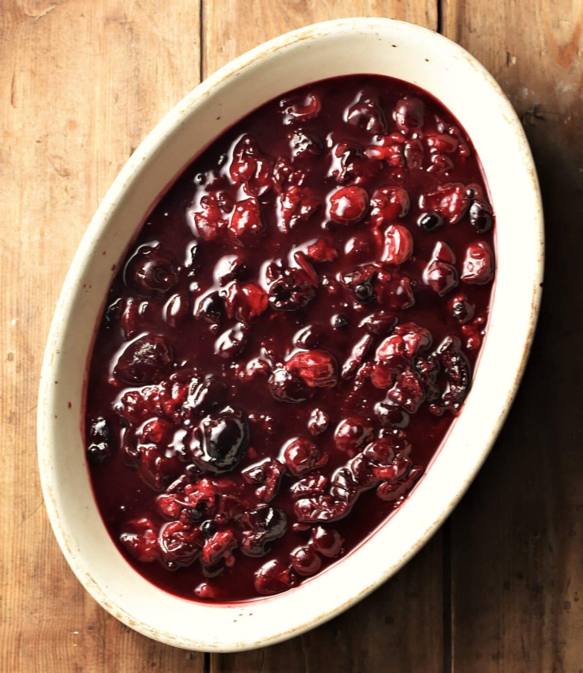 Cherry compote in white oval dish.