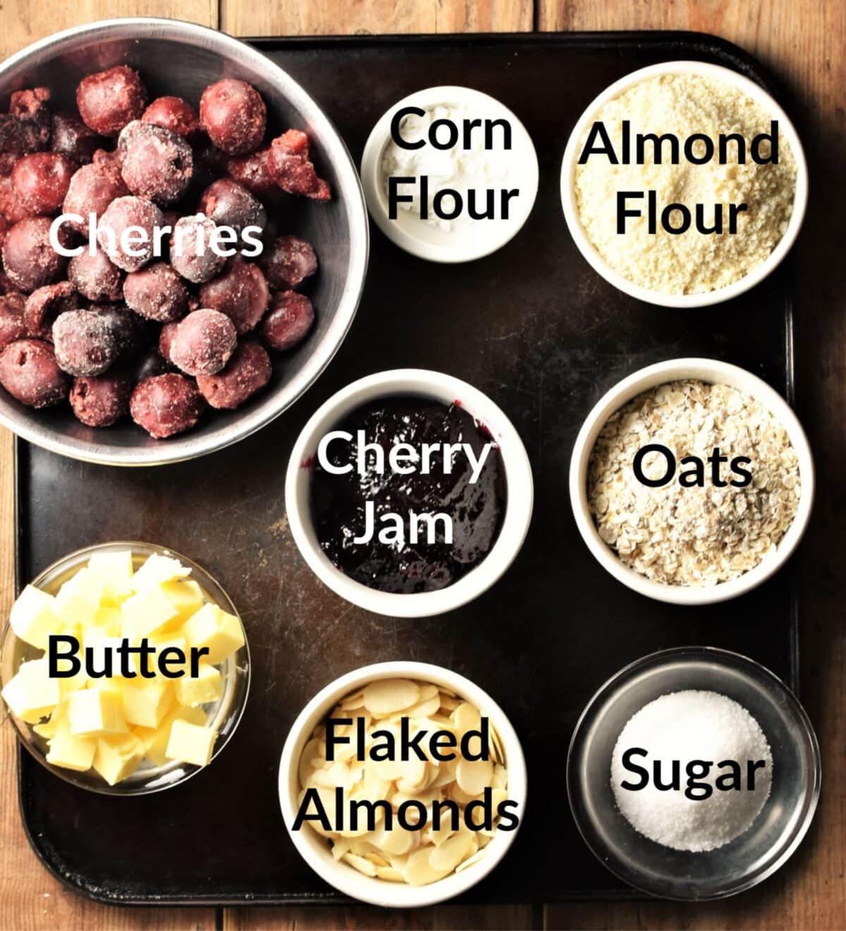 Cherry crumble ingredients in individual dishes.