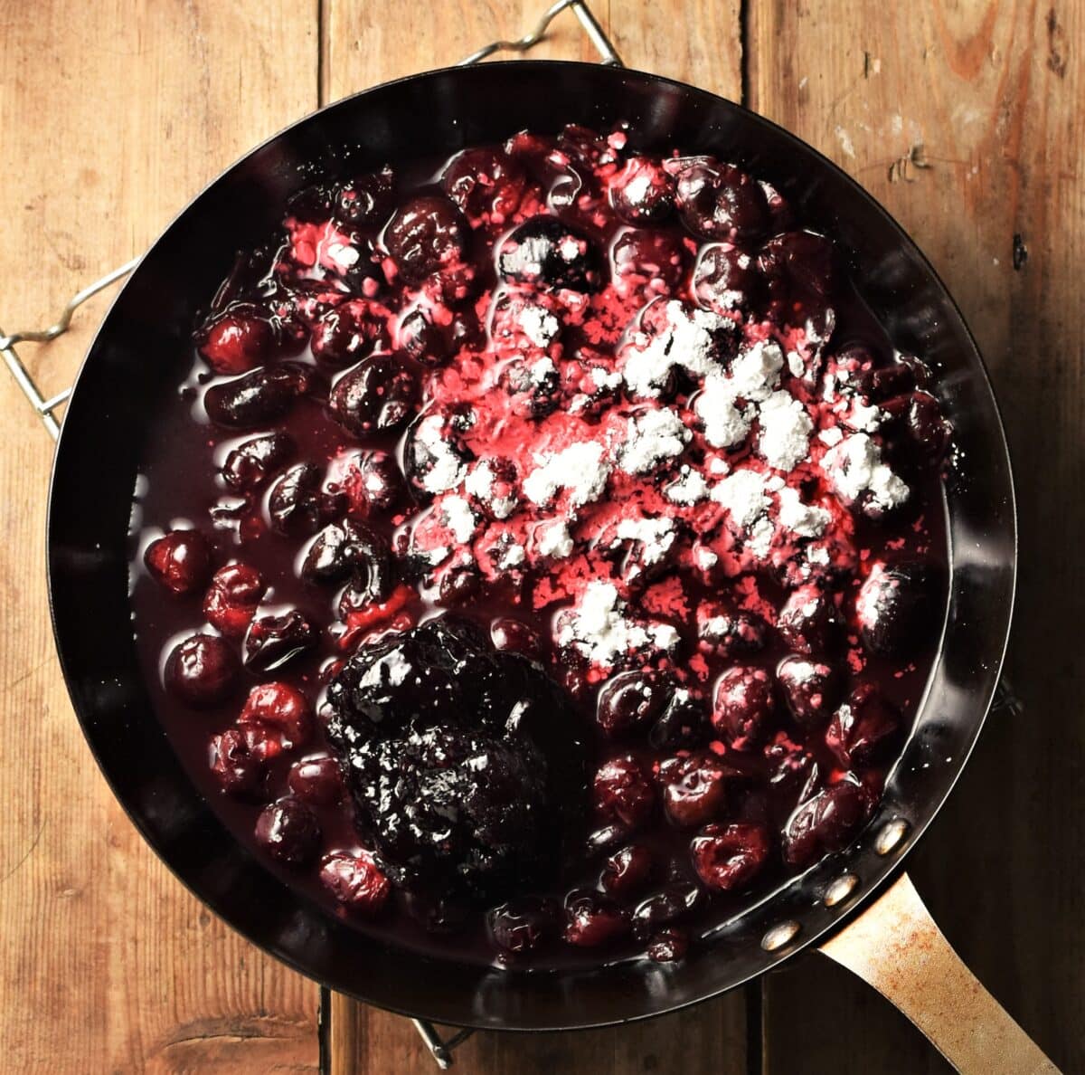 Cherry compote with flour in skillet.