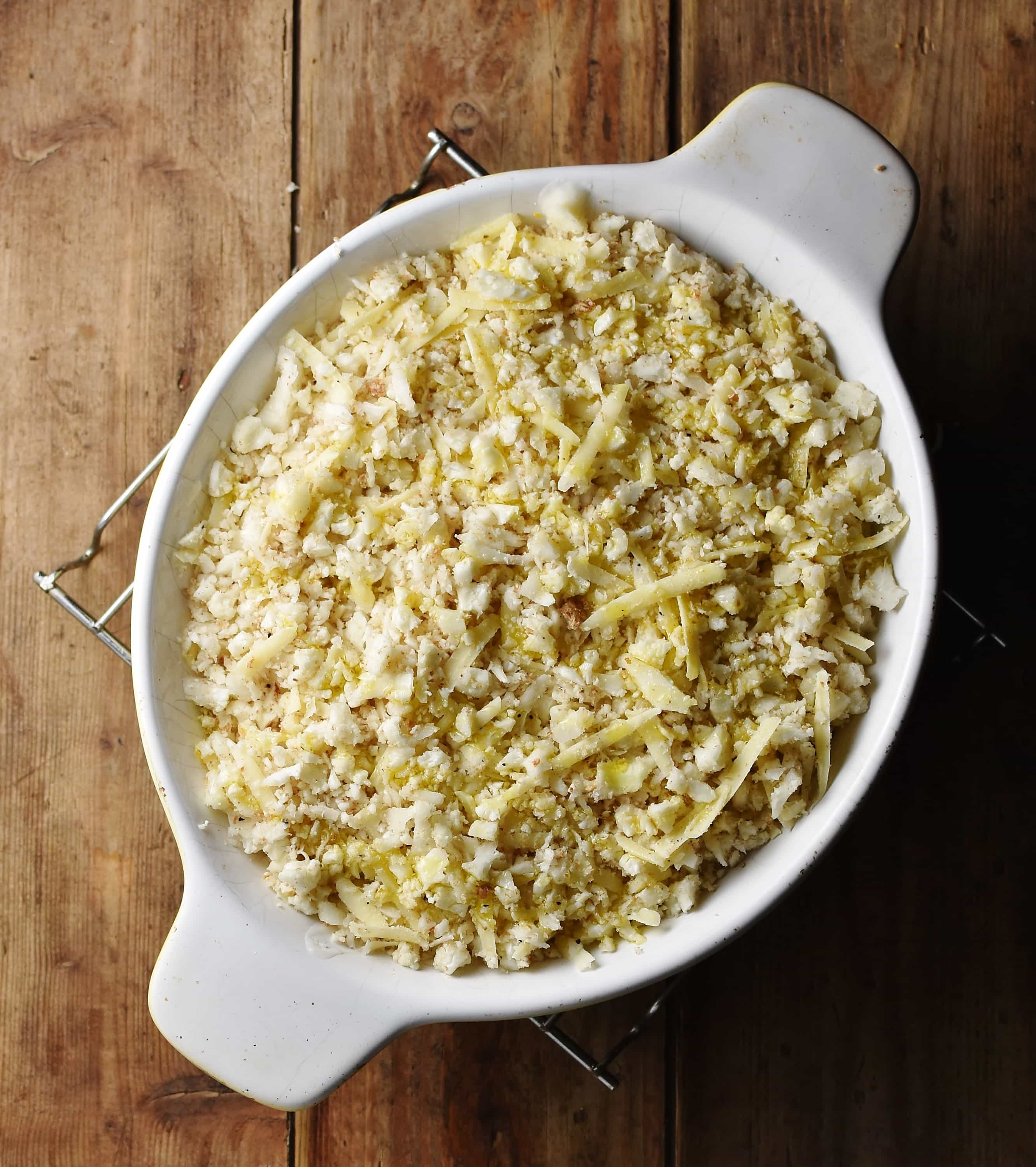 Pie in white oval dish topped with cauliflower rice.