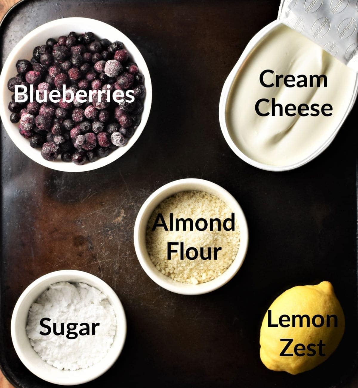 Blueberry cream cheese dessert ingredients in individual dishes.
