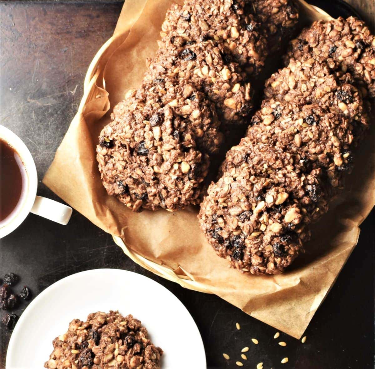 Top down view of chocolate oatmeal cookies on top of parchment and small plate.