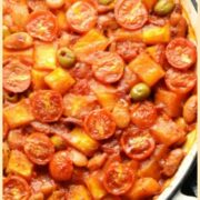 Top down partial view of butternut squash casserole in large shallow white dish.