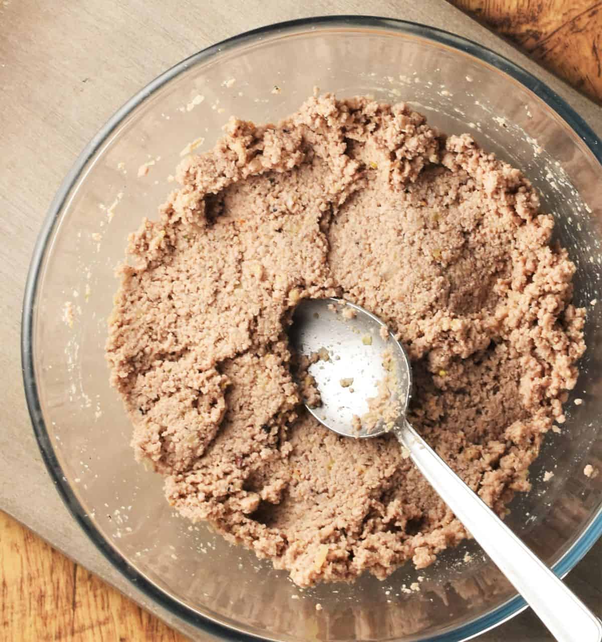 Polish meat pierogi filling mixture in bowl with spoon.