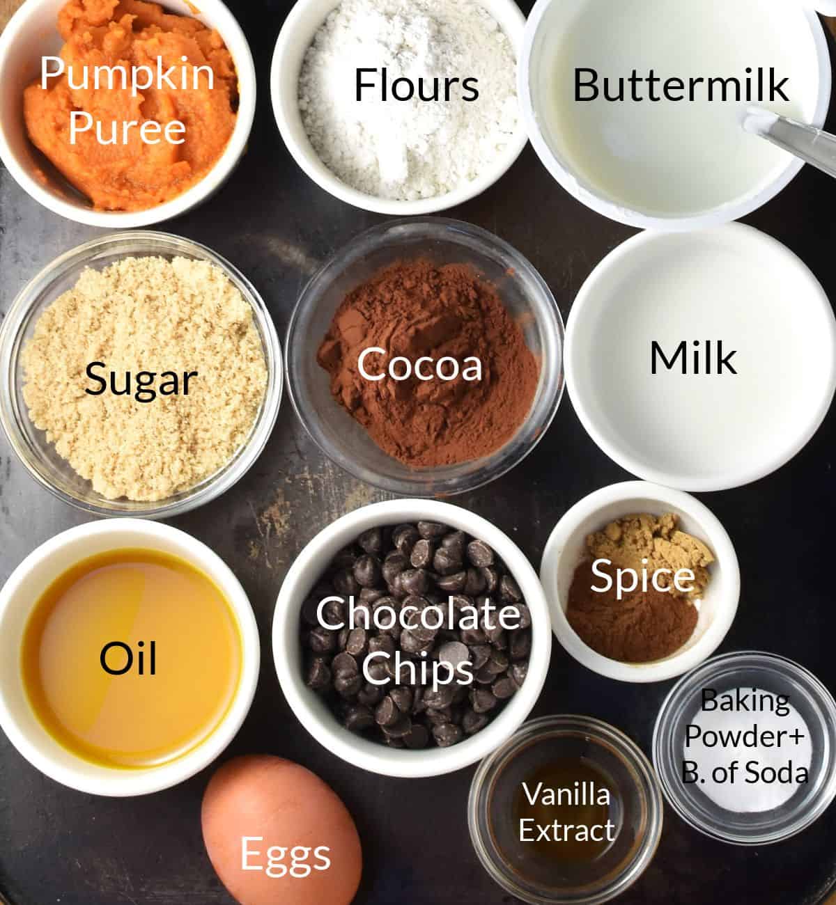 Ingredients for making chocolate and pumpkin muffins in individual dishes.