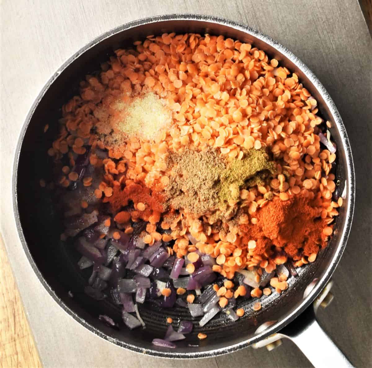 Cooking red lentil, onion and spices for roasted butternut squash soup.