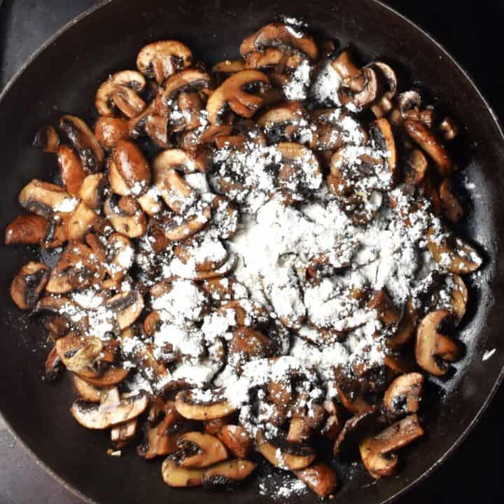 Browned mushrooms with flour in pan.