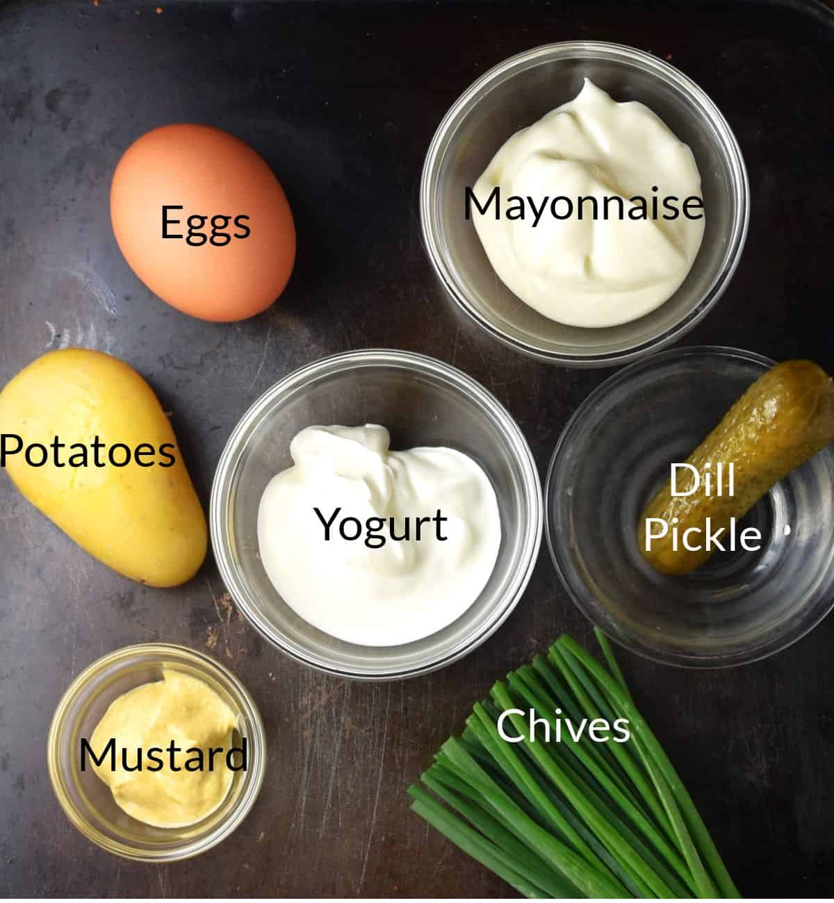 Ingredients for making potato salad deviled eggs in individual dishes.