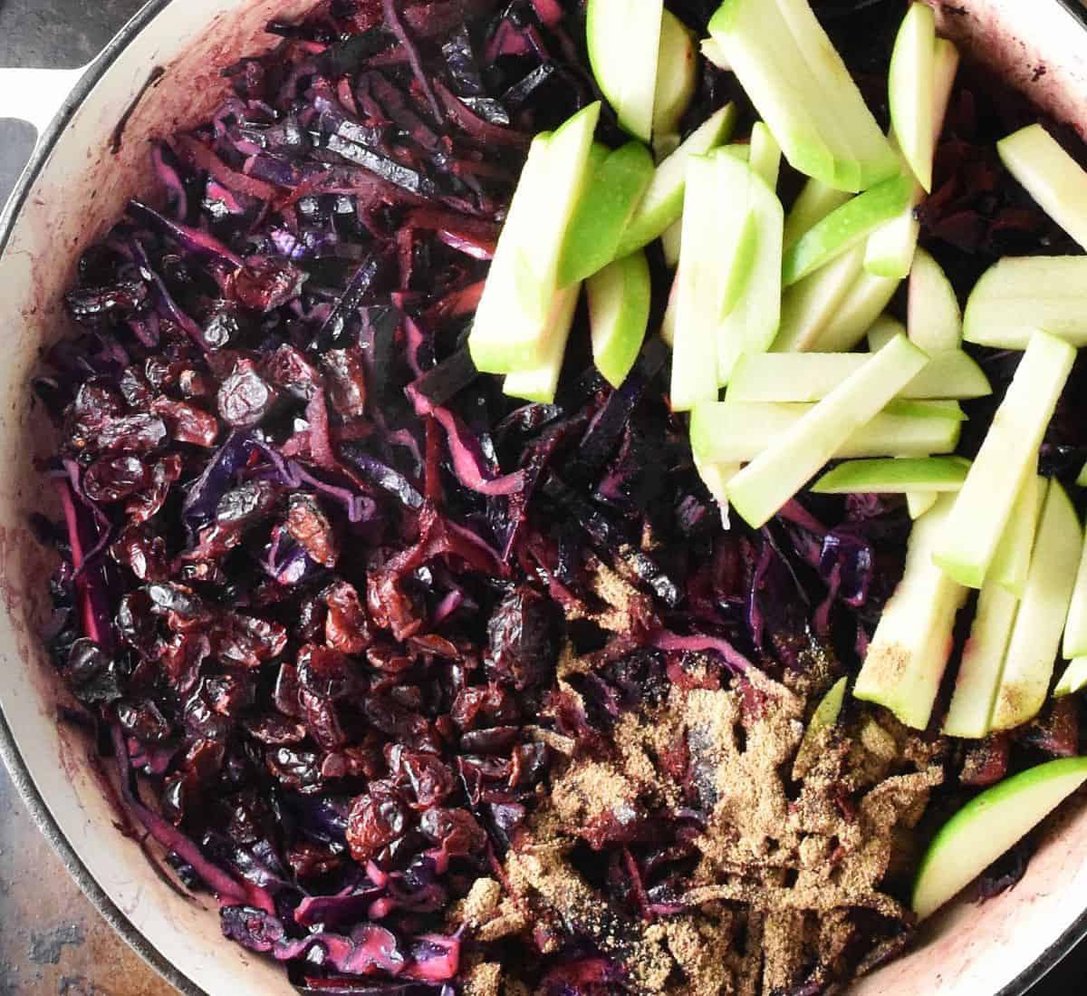 Top down view of braised red cabbage with julienned apple and spice in shallow dish.