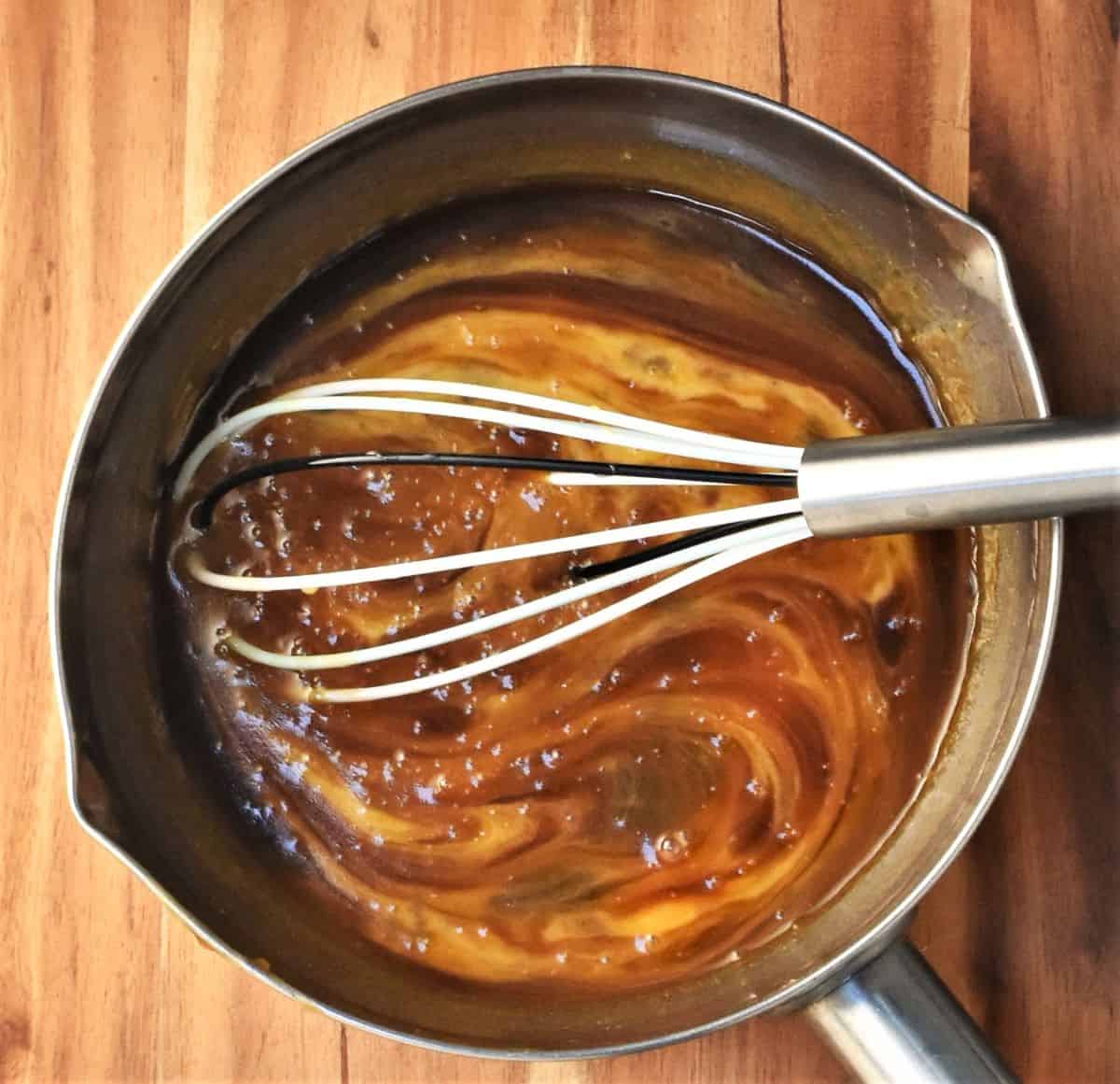 Whisking gingerbread mixture in saucepan.