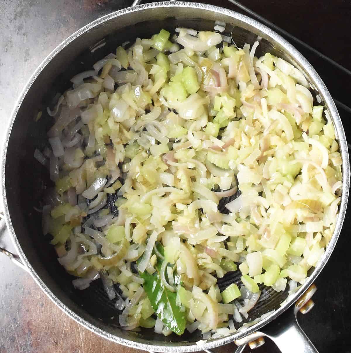 Top down view of chopped onion in large pot.
